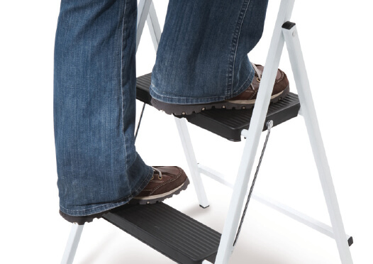 Person standing on two step ladder