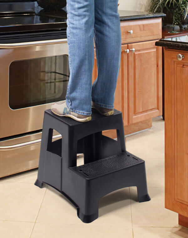 Person standing on two set stool