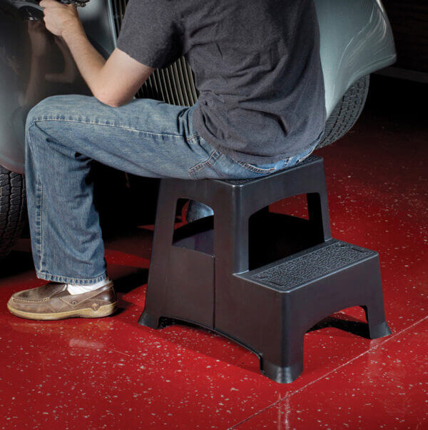 Person sitting on two step stool