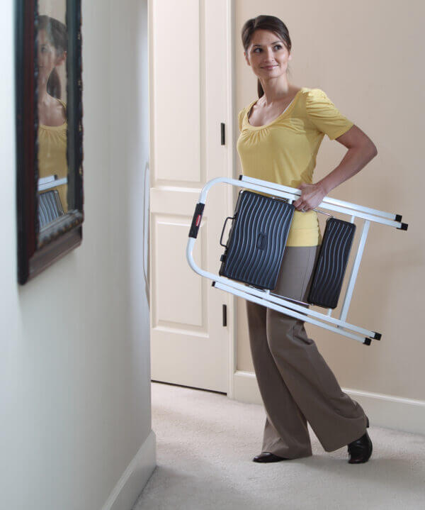 Person carrying folded ladder