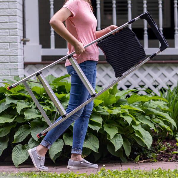 Woman carrying ladder