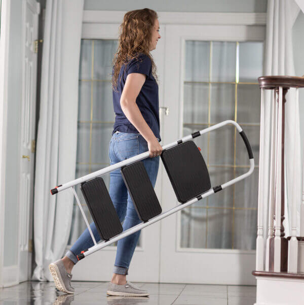 Person carrying three step ladder