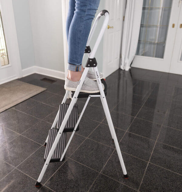 Person standing on three step ladder