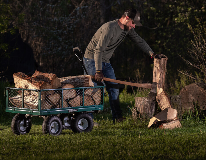 Man cutting wood using cart