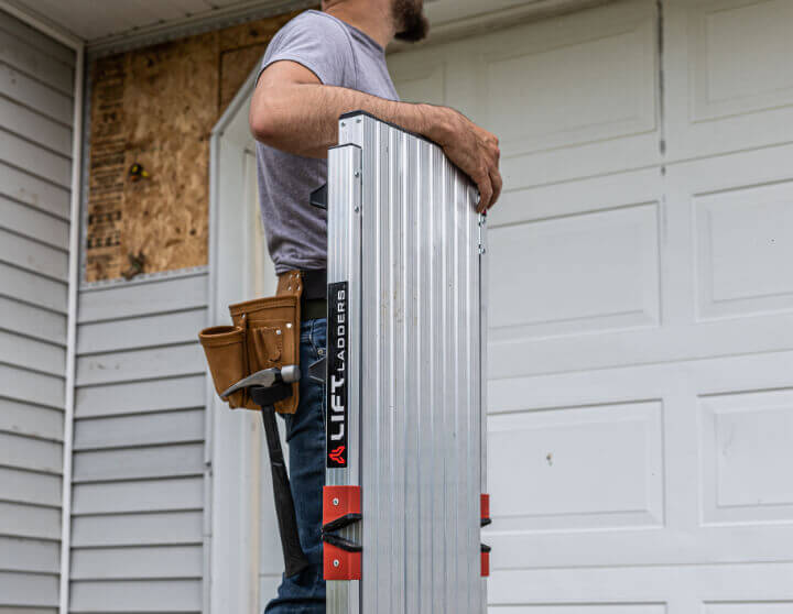 Man with tool belt carrying Lift Ladder bench